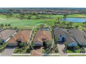 Stunning aerial view of a home on a golf course with lush greenery and a serene pond at 4632 Benito Ct, Lakewood Ranch, FL 34211