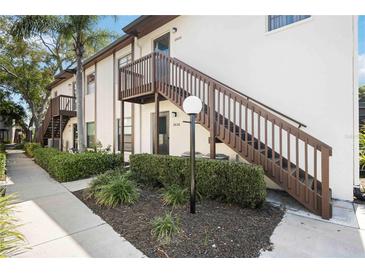 A condo building with beautiful landscaping and stairs to the front door at 2832 74Th W St # 2180, Bradenton, FL 34209