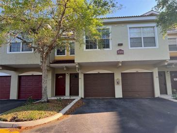 Two-story townhome featuring attached garages and well-maintained landscaping at 5701 Bentgrass Dr # 18-203, Sarasota, FL 34235