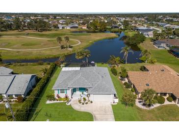 Aerial view of home on golf course with mature landscaping and waterfront views with pool and screened enclosure at 6 Bunker Cir, Rotonda West, FL 33947