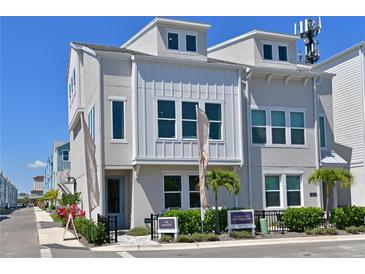 Beautiful townhome featuring neutral paint, decorative windows, and manicured landscaping at 2401 Ezzell Ct, Sarasota, FL 34237