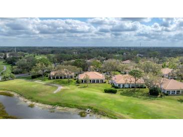 Stunning aerial view of homes overlooking a lush green golf course and community at 3982 Chatsworth Greene # 37, Sarasota, FL 34235