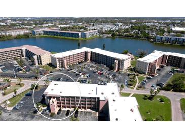 Scenic aerial view of condos and landscaping near a beautiful lake at 4133 Heron Way # E202, Bradenton, FL 34205