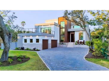 Modern home featuring a large driveway, a two-car garage, and a rooftop terrace at 603 Tremont St, Sarasota, FL 34242