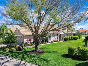 Charming single-story home featuring mature landscaping and a meticulously maintained lawn at 7052 Woodmore Ter, Lakewood Ranch, FL 34202