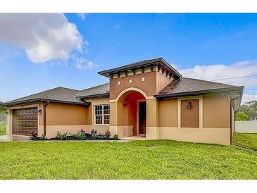 Charming single-story home with a covered entryway and well-manicured lawn at 1056 Tampa Rd, Venice, FL 34293