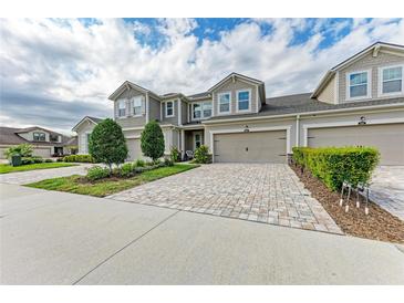 Charming two-story townhome featuring a private garage and a beautifully landscaped front yard at 11607 Meadowgate Pl, Bradenton, FL 34211