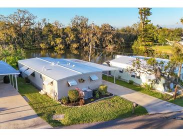 Charming single-story home with a well-maintained lawn and river in the background at 3912 14Th E St, Ellenton, FL 34222
