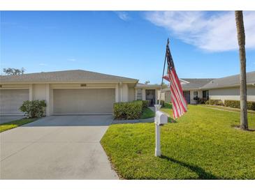 Charming single-story home featuring a well-manicured lawn and an attached one-car garage at 4348 Bowling Green Cir # 9, Sarasota, FL 34233