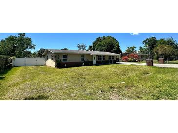 Charming single-story home featuring a well-maintained lawn and a partially bricked facade at 605 15Th Avenue E Dr, Palmetto, FL 34221