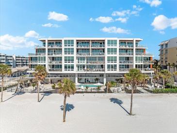 Beautiful beachfront condo building with large windows, pool, and beach access at 1035 Seaside Dr # 308, Sarasota, FL 34242