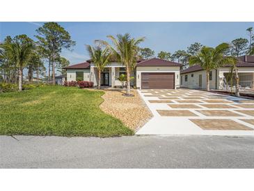 Beautiful single Gathering home with an attractive lawn, rock landscaping, and a decorative concrete driveway at 115 Solana St, North Port, FL 34287