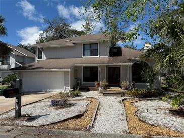 Charming two-story home featuring a well-maintained front yard and a welcoming entrance at 810 Hammockwood Ct, Sarasota, FL 34232