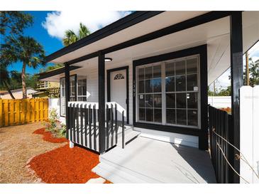 Inviting front exterior featuring white and black trim, enhanced by well-placed windows and a charming front porch at 1397 43Rd St, Sarasota, FL 34234