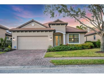 Charming single-story home featuring a brick driveway, well-maintained landscaping, and a neutral color palette at 3715 80Th E Dr, Sarasota, FL 34243