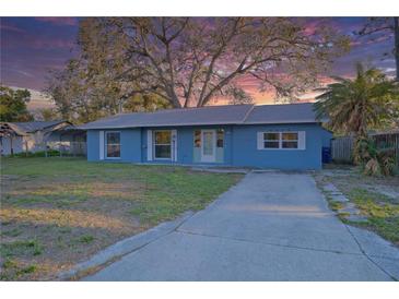 Charming blue single-story home with a well-maintained lawn and a concrete driveway leading to the front entrance at 4015 11Th W Ave, Bradenton, FL 34205