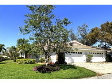 Charming single-story home with a well-manicured lawn and white exterior at 5638 Garden Lakes Palm, Bradenton, FL 34203