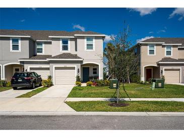 Charming townhomes featuring neutral color schemes, attached garages, and well-maintained landscaping at 5734 Archipelago St, Nokomis, FL 34275