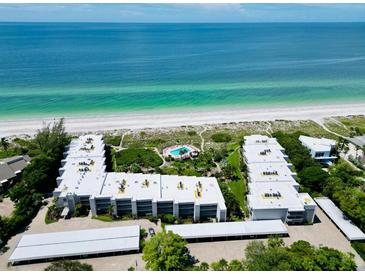 Stunning aerial view of beachfront condos, showcasing beautiful beaches and ocean views at 5757 Gulf Of Mexico Dr # 110, Longboat Key, FL 34228