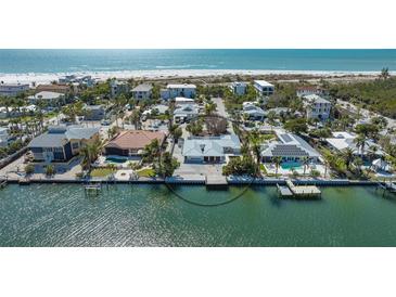 Stunning waterfront home with a private dock, beautiful landscaping, and Gulf views at 148 N Polk, Sarasota, FL 34236