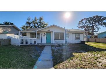 Charming single story home with a cheerful blue door and quaint front porch at 2109 19Th W St, Bradenton, FL 34205