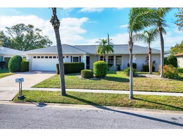 Charming one-story home with well-maintained lawn, mature landscaping, and a two car garage at 6722 Roxbury Dr, Sarasota, FL 34231