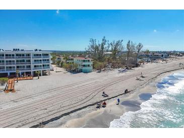 A beachfront property with stunning ocean views, sandy beach, and clear blue skies at 2350 N Beach Rd # 1B, Englewood, FL 34223