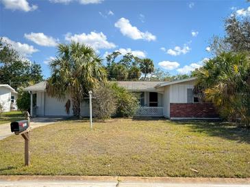 Charming single-story home with palm trees and well-maintained lawn at 2837 Woodcrest Dr, Sarasota, FL 34239