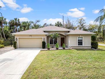 Charming single-story home featuring a two-car garage and beautiful landscaping at 3189 Seattle Ave, North Port, FL 34286
