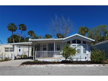 Charming single-story home with covered porch, carport, and lush landscaping in a serene neighborhood at 3333 26Th E Ave # 28, Bradenton, FL 34208
