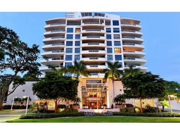 Stunning condo building featuring a symmetrical design with balconies and manicured landscaping at 401 S Palm Ave # 801, Sarasota, FL 34236
