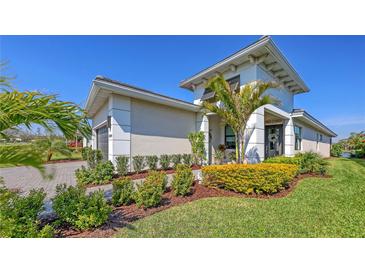 Beautiful single-Gathering home with a manicured lawn and lush tropical landscaping in a desirable neighborhood at 5209 Barnett Cir, Lakewood Ranch, FL 34211