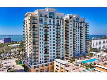 Luxury condo building featuring multiple balconies overlooking the beautiful bay and a refreshing outdoor swimming pool at 800 N Tamiami Trl # 312, Sarasota, FL 34236