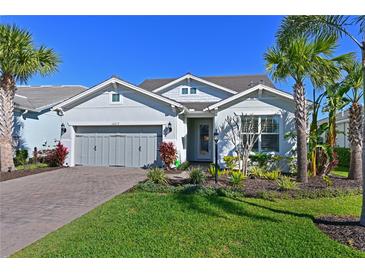 Charming single-story home with lush landscaping and a brick driveway at 12217 Cranston Way, Lakewood Ranch, FL 34211