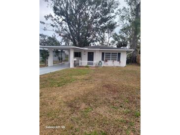 Charming home with a quaint white picket fence, carport, and simple landscaping at 1807 27Th W St, Bradenton, FL 34205