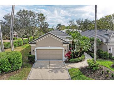 Charming home features a well-manicured lawn, lush landscaping, and a two-car garage at 8782 49Th E Ter, Bradenton, FL 34211