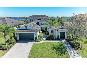 Beautiful single Gathering home with lush landscaping, two-car garage, and brick driveway at 5602 Tidewater Preserve Blvd, Bradenton, FL 34208