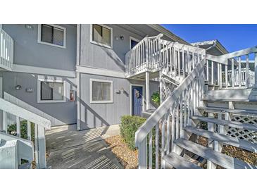 Exterior view of a two-story condo building with stairs leading to the second level at 6033 34Th W St # 35, Bradenton, FL 34210