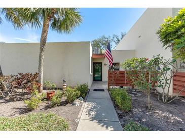 Charming single-story home with a well-maintained walkway, inviting curb appeal, and colorful landscaping at 622 Spring Lakes Blvd, Bradenton, FL 34210