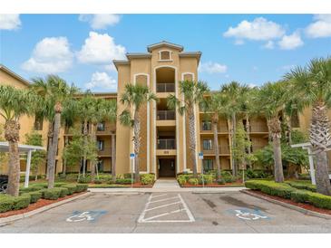Beautiful condo building showcasing tropical landscaping and accessible parking spots at 6519 Grand Estuary Trl # 101, Bradenton, FL 34212