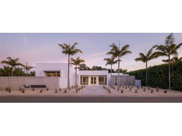 Modern home exterior featuring sleek lines, minimalist landscaping, and striking palm trees at twilight at 1354 Westway Dr, Sarasota, FL 34236