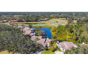 Stunning aerial view of homes overlooking the golf course and lake at 3008 Highlands Bridge Rd, Sarasota, FL 34235