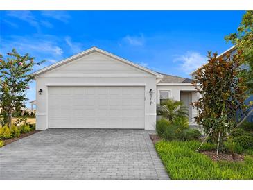 Charming home featuring a two-car garage with brick paver driveway and nicely landscaped front yard at 3707 Ambersweet Crossing, Parrish, FL 34219