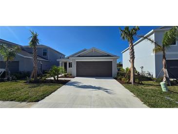 Charming single Gathering home with well-manicured lawn and freshly planted palm trees at 9060 Tequila Sunrise Dr, Sarasota, FL 34241