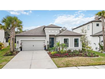 Charming single-story home boasts lush landscaping and a welcoming two-car garage at 10179 Milky Way Cir, Sarasota, FL 34241