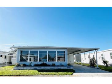 Charming single-story home featuring a screened-in porch and attached carport in a well-maintained community at 3232 Ash Ter, Sarasota, FL 34237