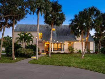Charming home featuring lush landscaping, a welcoming walkway, and inviting exterior lighting at 3648 Beneva Oaks Blvd, Sarasota, FL 34238
