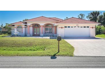 Charming single-Gathering home with a red tile roof, manicured lawn, and two car garage, perfect for a Gathering at 108 Mccabe St, Port Charlotte, FL 33953