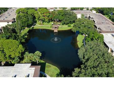 Beautiful aerial view of a well-maintained community with a tranquil pond and lush landscaping at 315 30Th W Ave # B214, Bradenton, FL 34205
