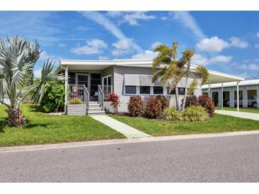 Charming single-story home with well-maintained landscaping and inviting front entrance, carport, and mature palm trees at 4304 14Th E St, Ellenton, FL 34222